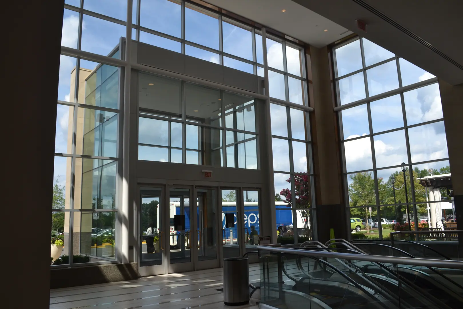 A large glass building with many windows and some steps