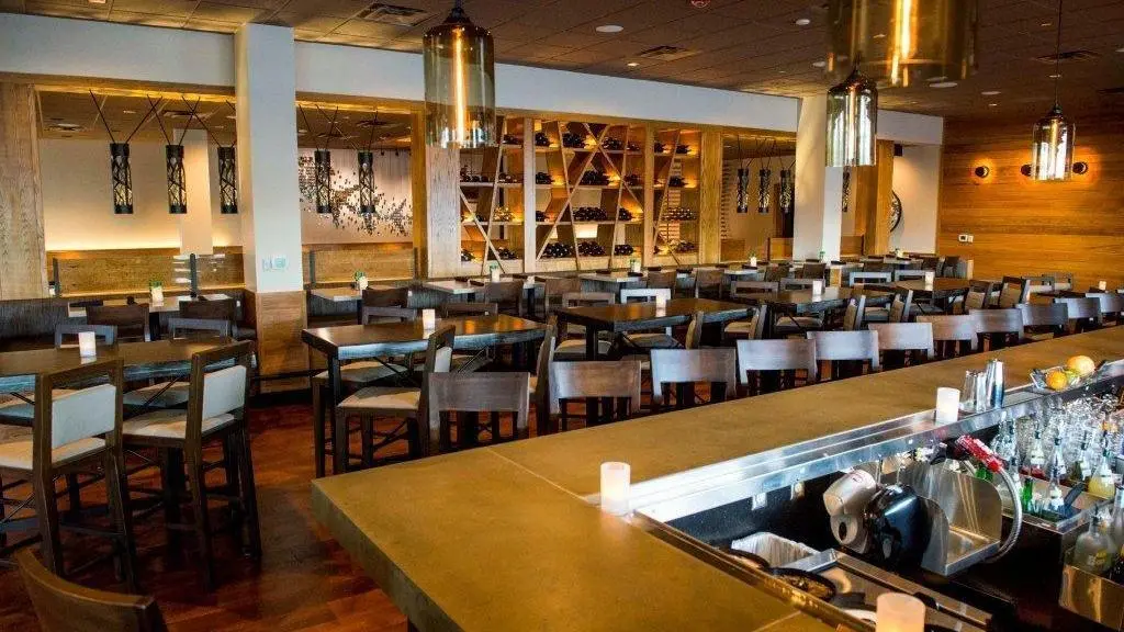 A restaurant with many chairs and tables in it