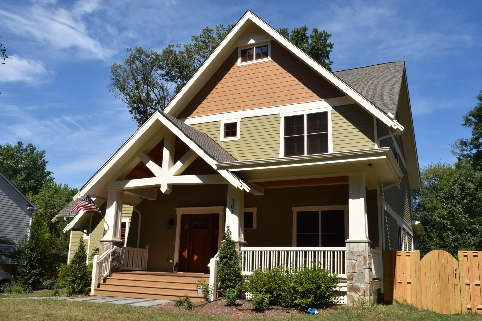 A house with a porch and steps leading to the front door.